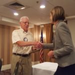 Former Rotary President Jim Becker accepting an award from New Club President Amanda Filizetti.