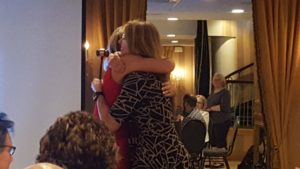 Lucy and Amanda hugging during Amanda's last meeting as Marquette West Rotary President.